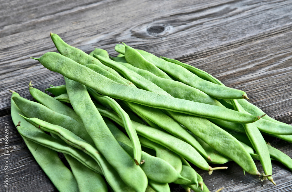 Fresh Roma II Italian Bush Bean or Romano Pole Bean (Phaseolus vulgaris) on wooden background. Fresh Roma II Italian Bush Bean or Romano Pole Bean (Phaseolus vulgaris) on wooden background.