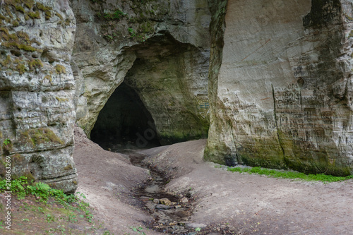 Natural cave in sandstone rock. Entrance to the cave called Little Hell in the Gauja National Park  Latvia.