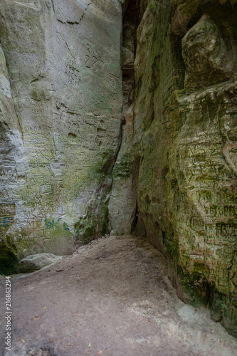Old inscriptions in the cave called Little Hell. Gauja National Park, Latvia. Soft focus.