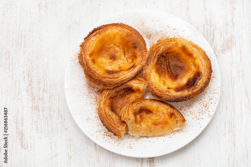 typical portuguese egg tart pastel de nata with cinnamon typical portuguese egg tart pastel de nata with cinnamon