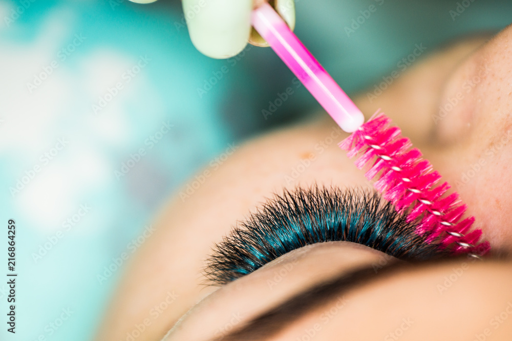 The master of eyelash extensions, the beautician increases eyelashes to the client in the conditions of norm of a disinfection in a beauty salon The master of eyelash extensions, the beautician increases eyelashes to the client in the conditions of norm of a disinfection in a beauty salon