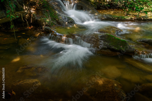 The water fall in the forest with sunlight