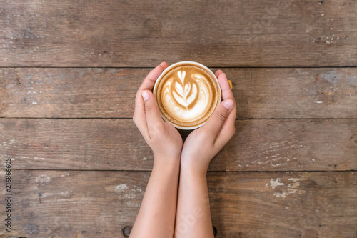 coffee cup in hand on coffee shop.