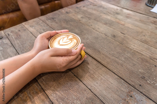 coffee cup in hand on coffee shop.