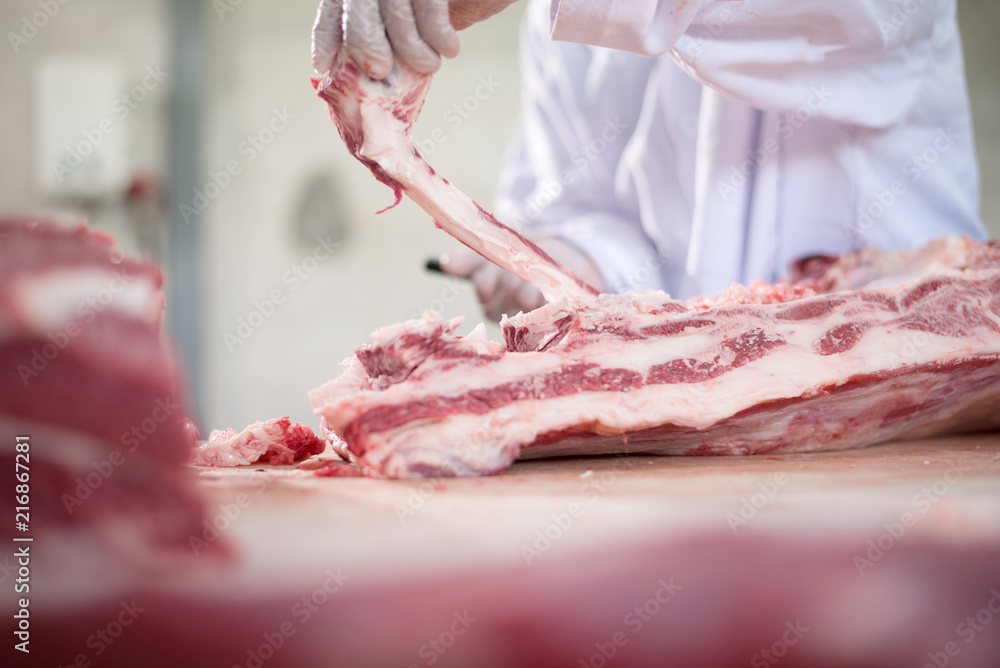 Butcher cutting pork meat food industry concept