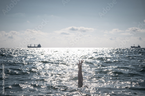 single hand of drowning man in sea asking for help © YURII Seleznov