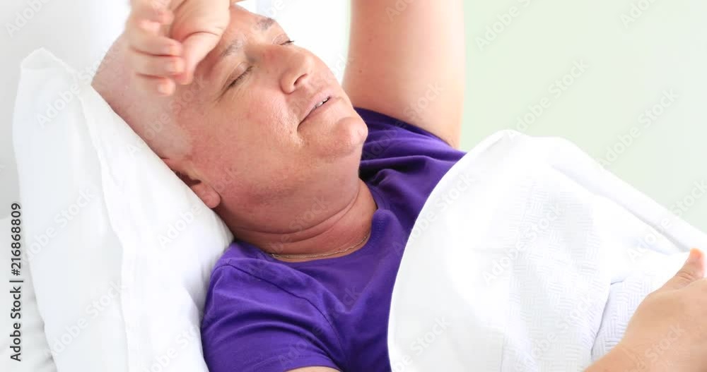 Painful cancer patient laying on bed in hospital room Painful cancer patient laying on bed in hospital room