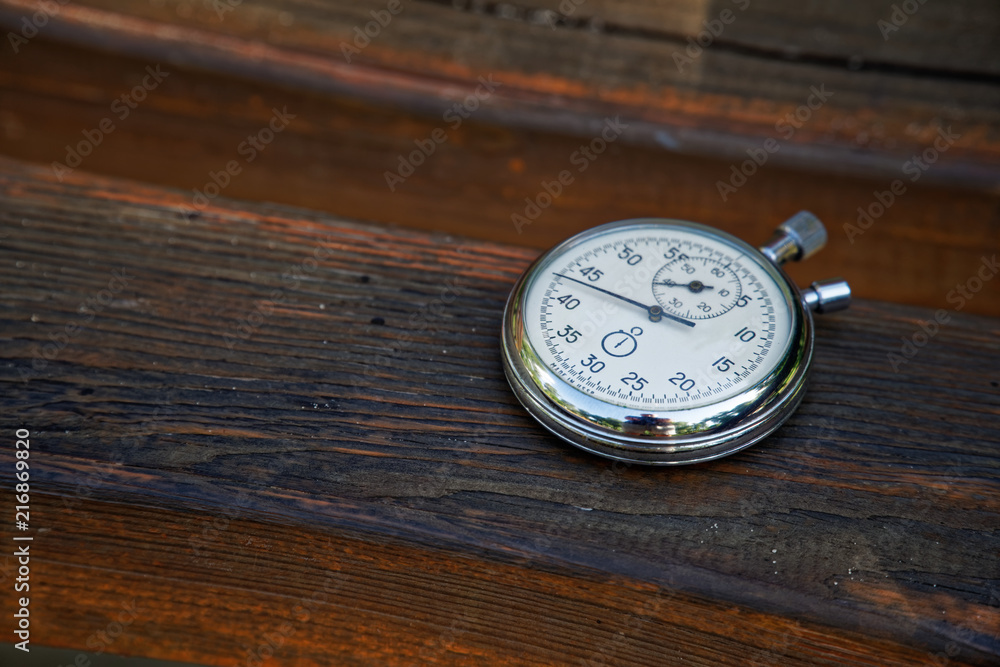 Sport watch on bench made of wood Sport watch on bench made of wood