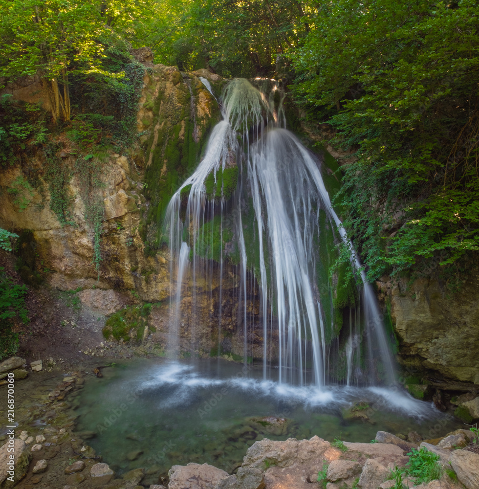 Obraz premium Mountain River with, forest landscape. Tranquil waterfall scenery in the middle of green forest
