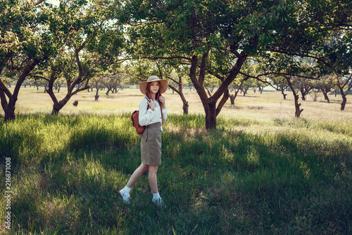 young girl in a straw hat travels green meadows © YURII Seleznov