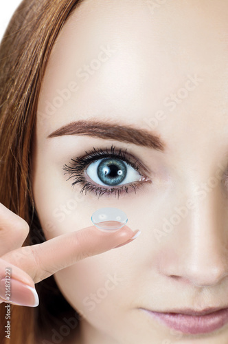 Young woman wearing contact lens.