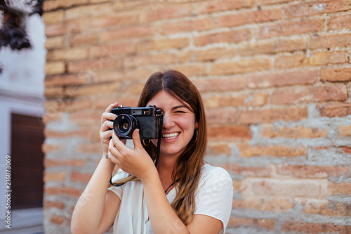 Young girl posing with a vintage camera photo