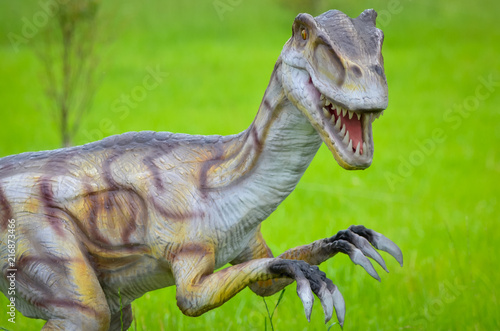 Big model of velociraptor in nature photo