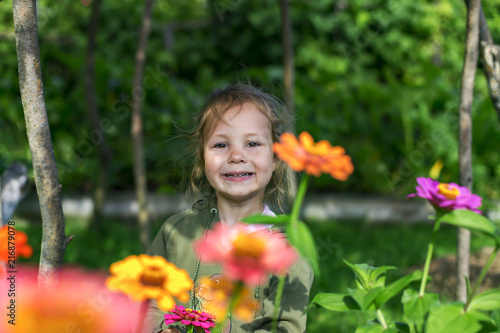 little and happy girl on flowers background
