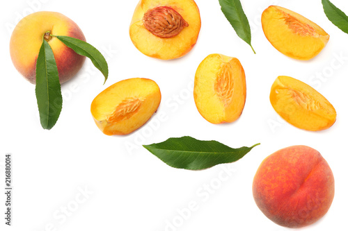 Fototapeta Naklejka Na Ścianę i Meble -  peach fruit with green leaf and slices isolated on white background. top view