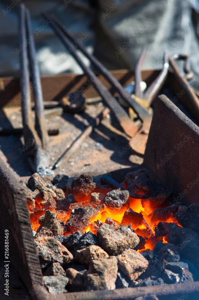 blacksmith performs the forging of hot glowing metal on the anvil blacksmith performs the forging of hot glowing metal on the anvil