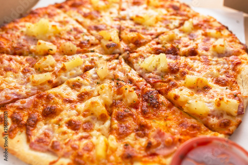 Close up of tasty hawaiian pizza with ham and pineapple