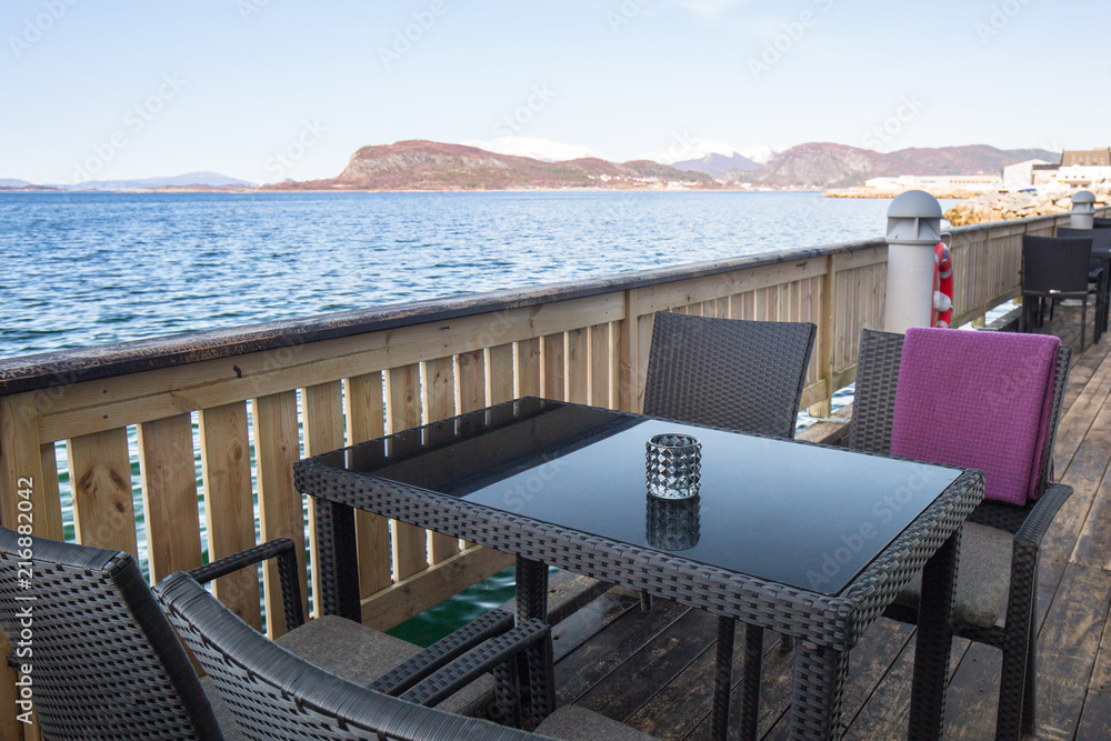 Table at the sea in Alesund town, Norway