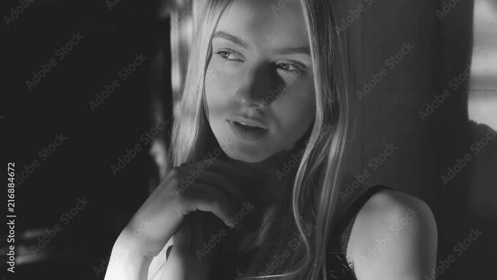 Black and white art fashion surrealistic portrait of beautiful woman with a beamof light and shadow on her face Black and white art fashion surrealistic portrait of beautiful woman with a beamof light and shadow on her face