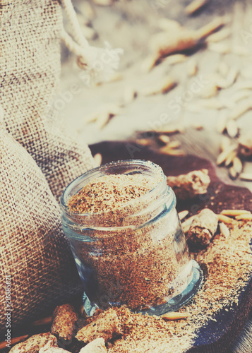 Healthy eating concept: oat bran, oat grain, ground oats, vintage wooden background, selective focus and toned image