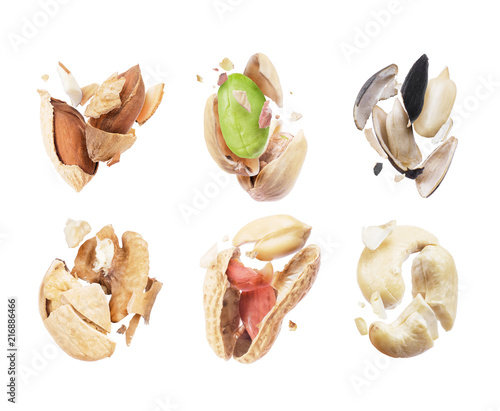 Set of broken nuts and seeds close-up on white background