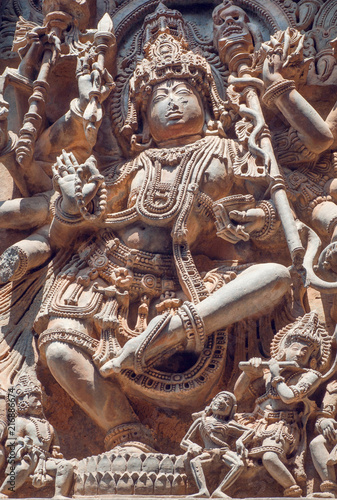 Dancing Shiva deadly dance on carved wall of 12th century historical Hoysaleswara Hindu temple, Halebidu, India.