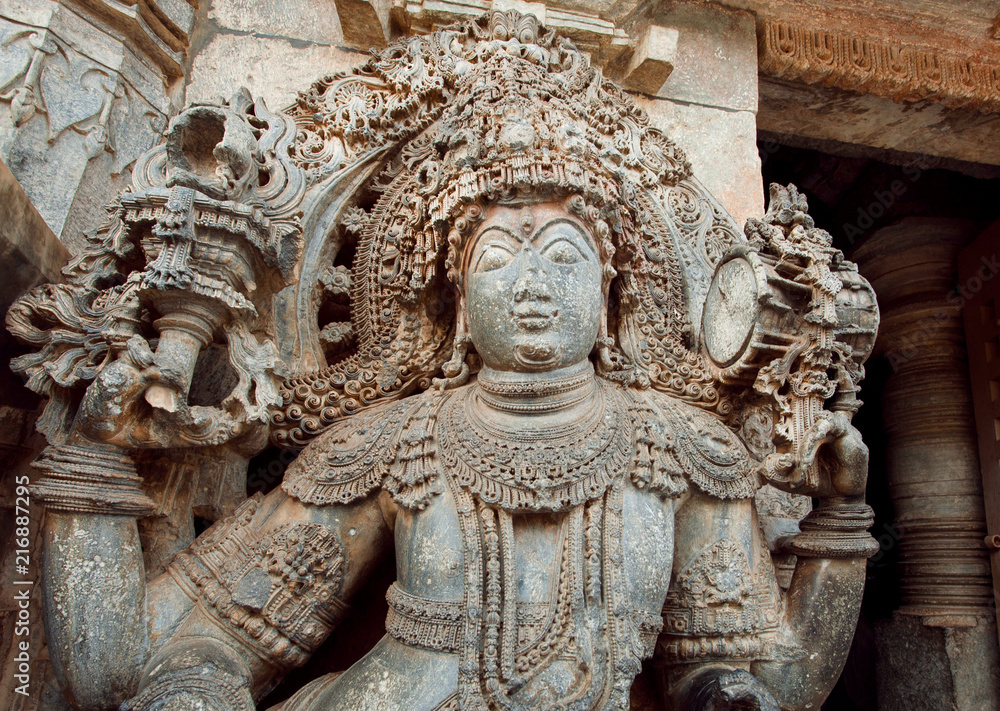 Sculpture of a guard at entrance of carved 12th century historical Hoysaleswara Hindu temple, Halebidu, India.