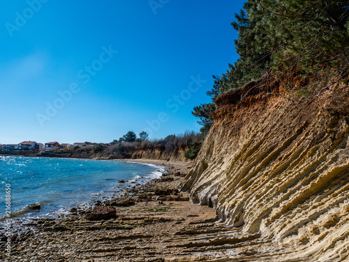 Beautiful orange cliff rocks on Adriatic sea coast, island Vir, Mediterranean, Croatia