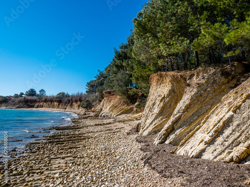 Beautiful orange cliff rocks on Adriatic sea coast, island Vir, Mediterranean, Croatia