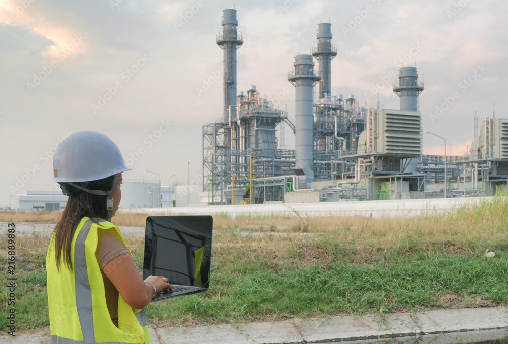 custom made wallpaper toronto digitalEngineering women are checking oil refineries and gas stations on notebooks. In the industrial area.