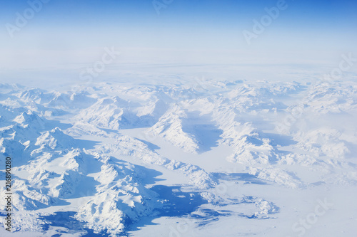 Blue and white winter snow landscape from plane above over iceland traveling from Keflavik to canada