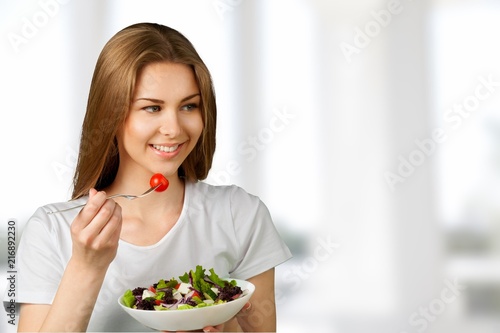 Attractive caucasian woman with salad on background