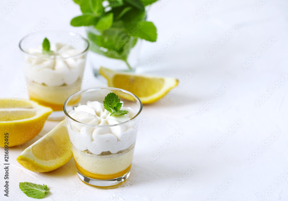 Limoncello - italian Dessert. Lemon Cheesecake Mousse with Whipped Cream in cups. Summer dessert. Limoncello - italian Dessert. Lemon Cheesecake Mousse with Whipped Cream in cups. Summer dessert.