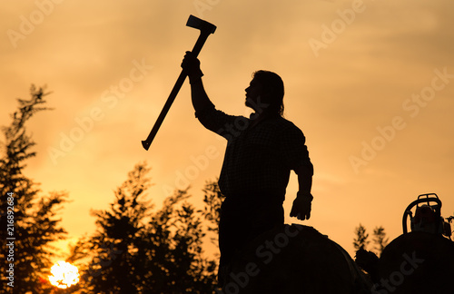 Lumberjack with ax at sunset