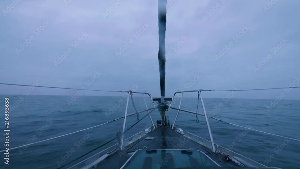 Ship sailing on sea waves on cloudy horizon background view from bow Ship sailing on sea waves on cloudy horizon background view from bow