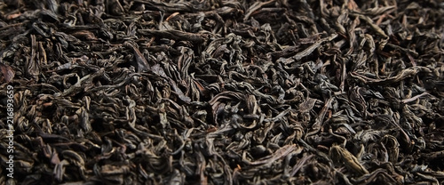 Black tea loose dried leaves. Background