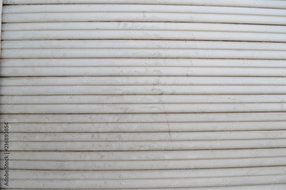 Obraz premium Closeup photograph of white, grungy window blinds.