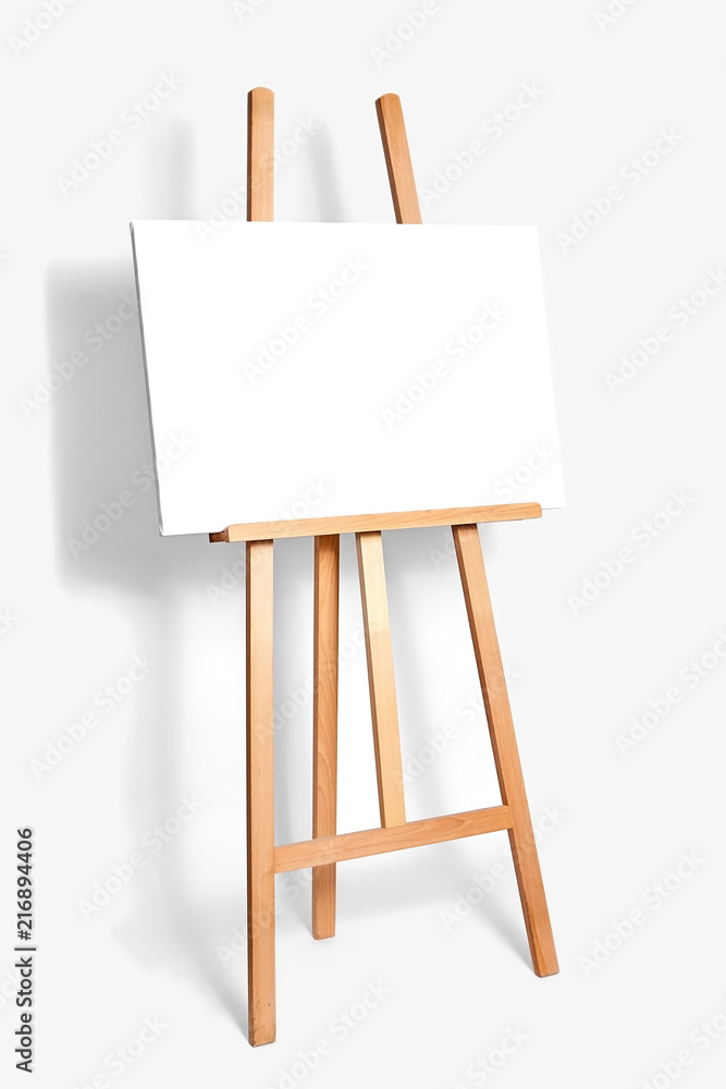 pure white synthetic canvas stretched on a wooden stretcher standing on a wooden easel for artists. Gray monophonic background. Art, creativity, hobby, job and creative occupation concept pure white synthetic canvas stretched on a wooden stretcher standing on a wooden easel for artists. Gray monophonic background. Art, creativity, hobby, job and creative occupation concept