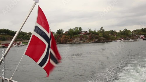 Norwegian flag waving behind boat