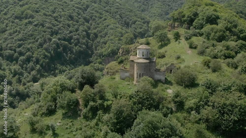 Departure on the dune around the ancient dilapidated Christian church standing high on the mountain. Erial View. North Caucasus. Russia Departure on the dune around the ancient dilapidated Christian church standing high on the mountain. Erial View. North Caucasus. Russia