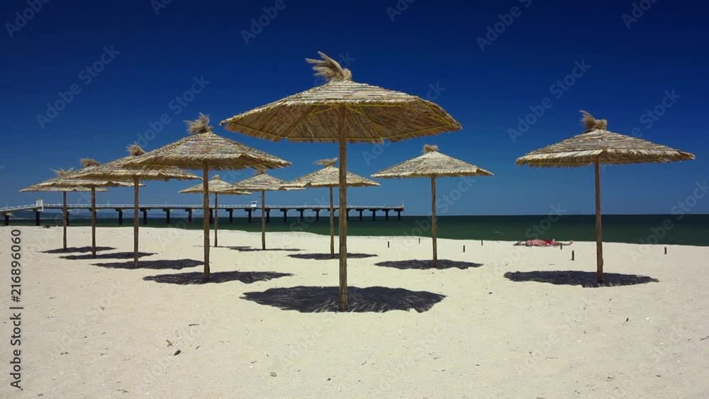 Straw ubmrellas, beach in Shkorpilovtsi, Bulgaria Straw ubmrellas, beach in Shkorpilovtsi, Bulgaria