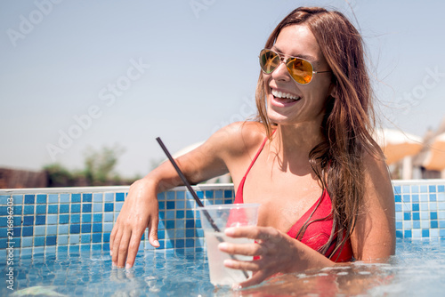 Beautiful young woman with glass of lemonade