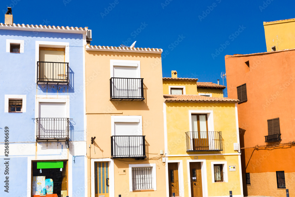 Close-up details of colorful houses against a blue sky in the village of Villajoyosa in southern Spain.