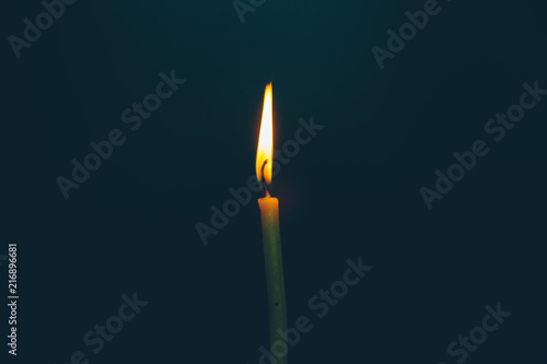 burning church candle on a black background