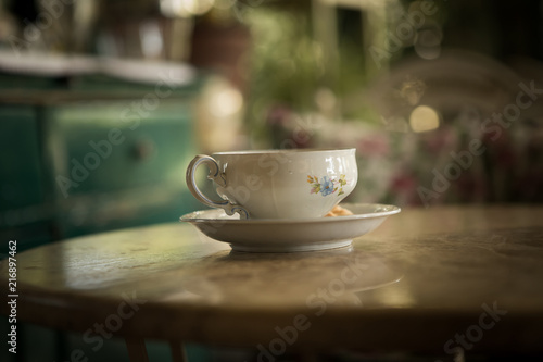 An old cup of tea on the table.
