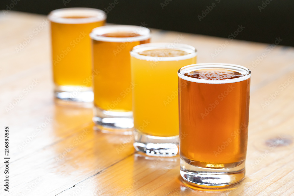 Flight of craft beer in a diagonal row Flight of craft beer in a diagonal row