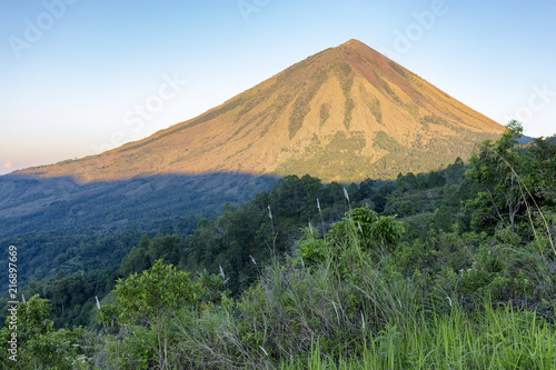 Dawn sunlight illuminates Mount Inerie on Flores in Indonesia. photo