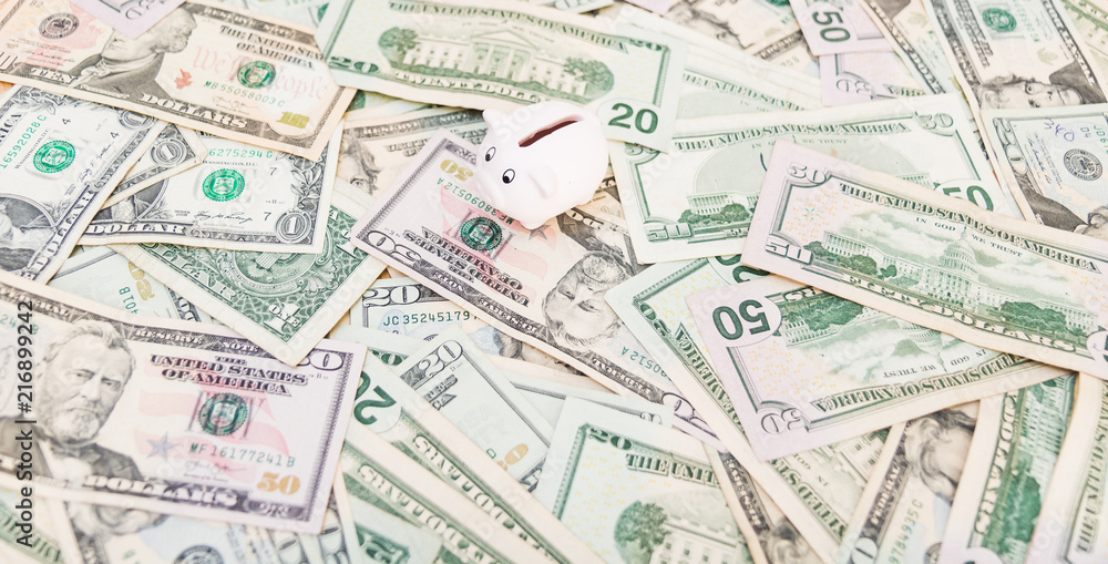 Piggy bank with a lot of American Dollars; investment and banking concepts Piggy bank with a lot of American Dollars; investment and banking concepts