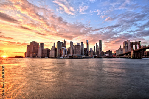New York City Lower Manhattan with Brooklyn Bridge at Sunset