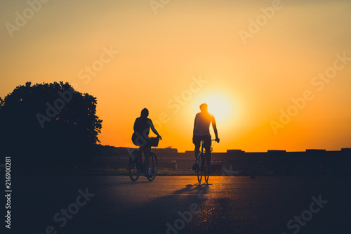 couple / two people riding bicycle 